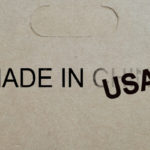 A "Made in China" stamp is replaced with "USA" on a package to misrepresent its source location.